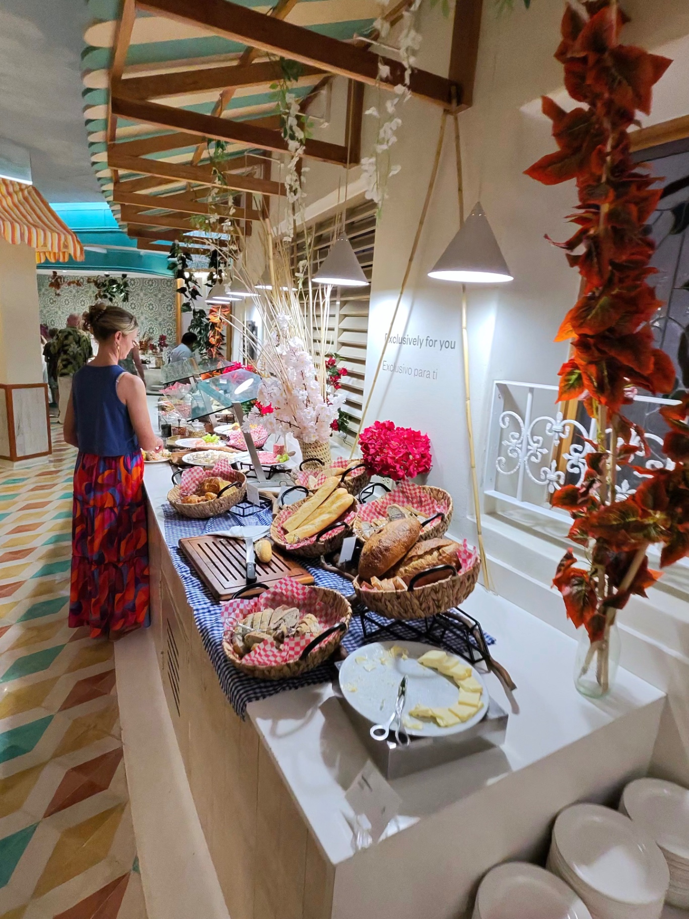 Bread and pastry station with baskets and floral decor