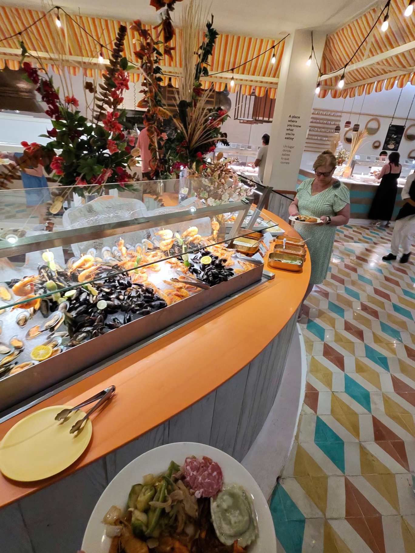 Buffet seafood station with mussels, shrimp, and fresh flowers
