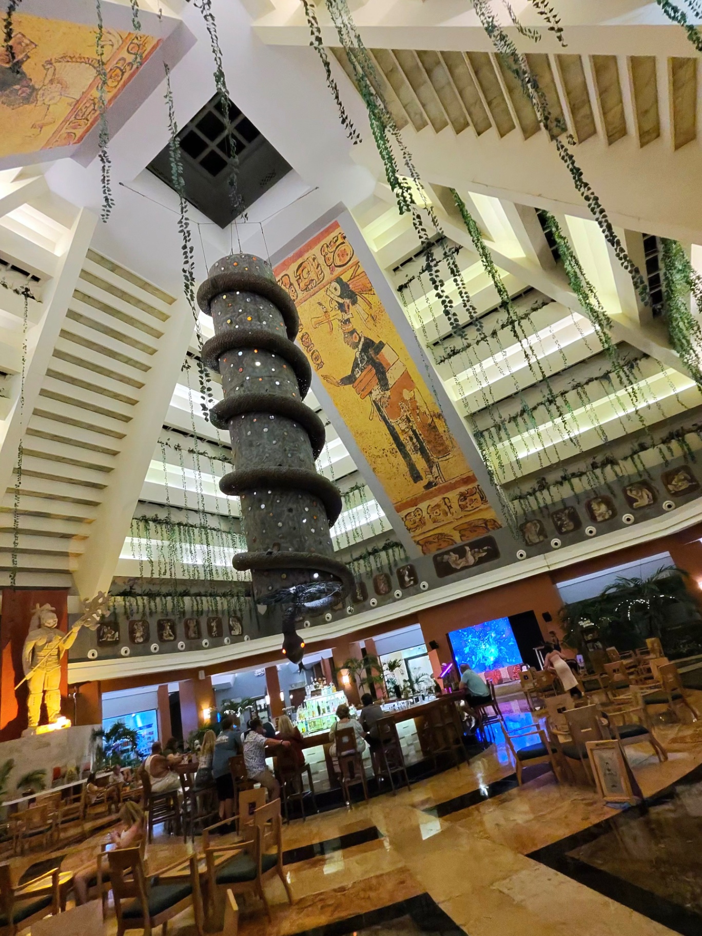 Grand Mayan-themed lobby with hanging vines and mural at Iberostar Paraiso Maya