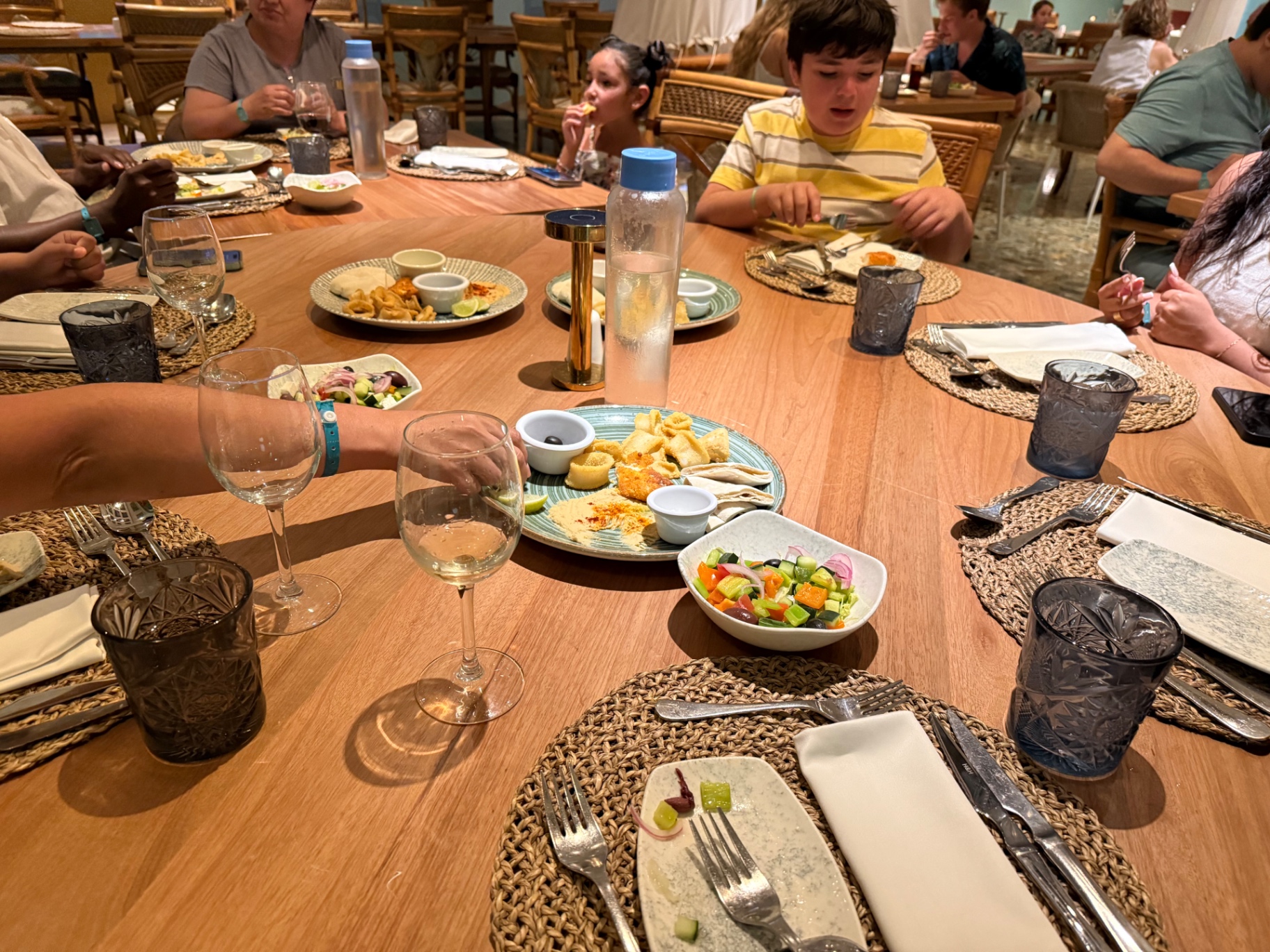 Family-style dinner spread with Mediterranean small plates
